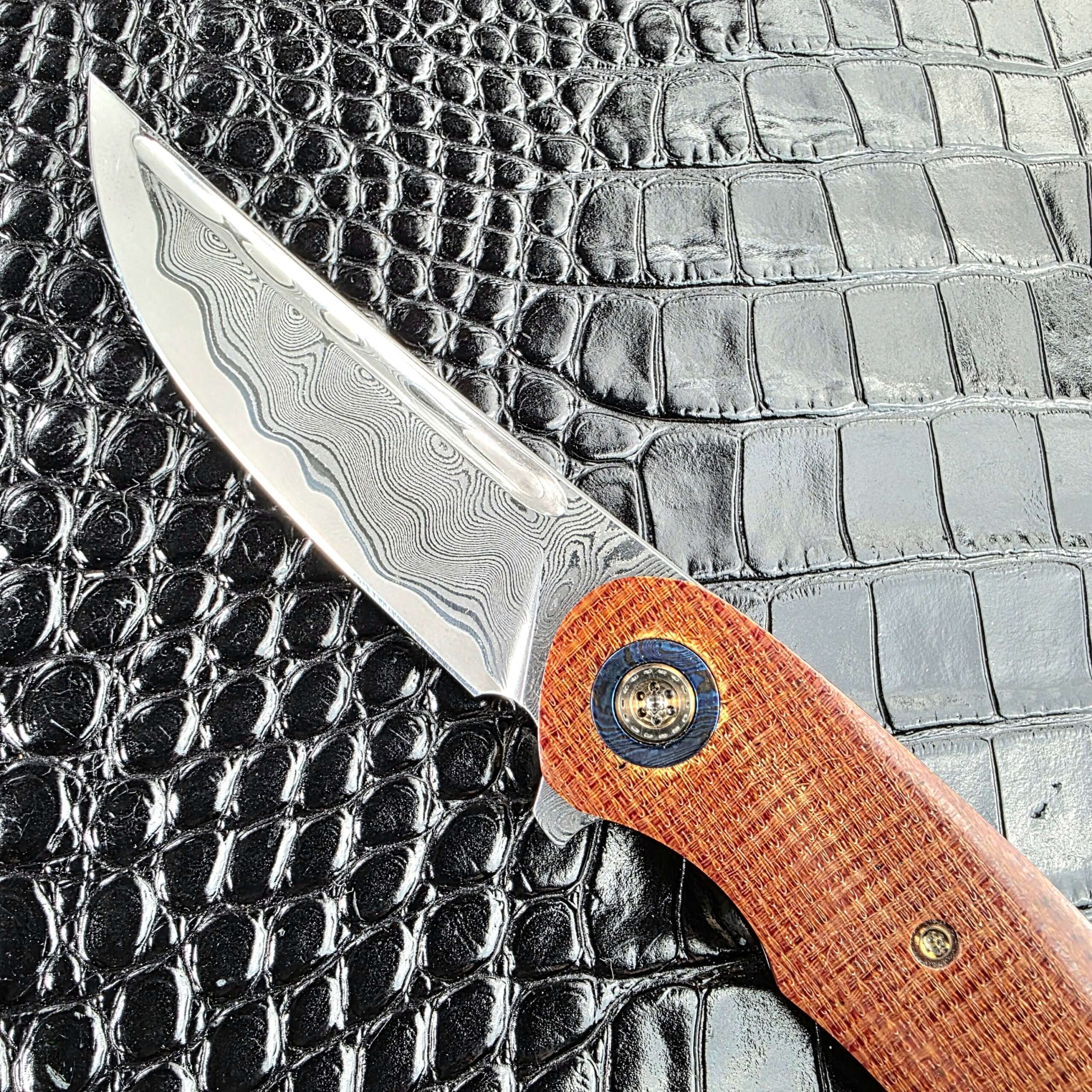 Drop point tip of the san mai Damascus blade on the Andriy Mozil Model 23-26