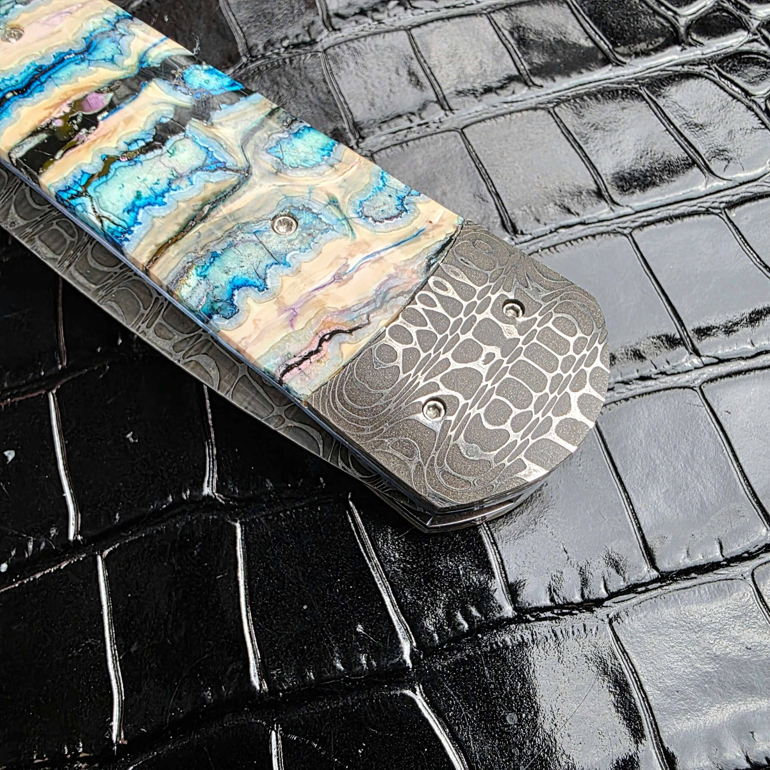 Rear Damascus bolster and mammoth molar scale at the butt of the Burn Knives Automatic Dagger