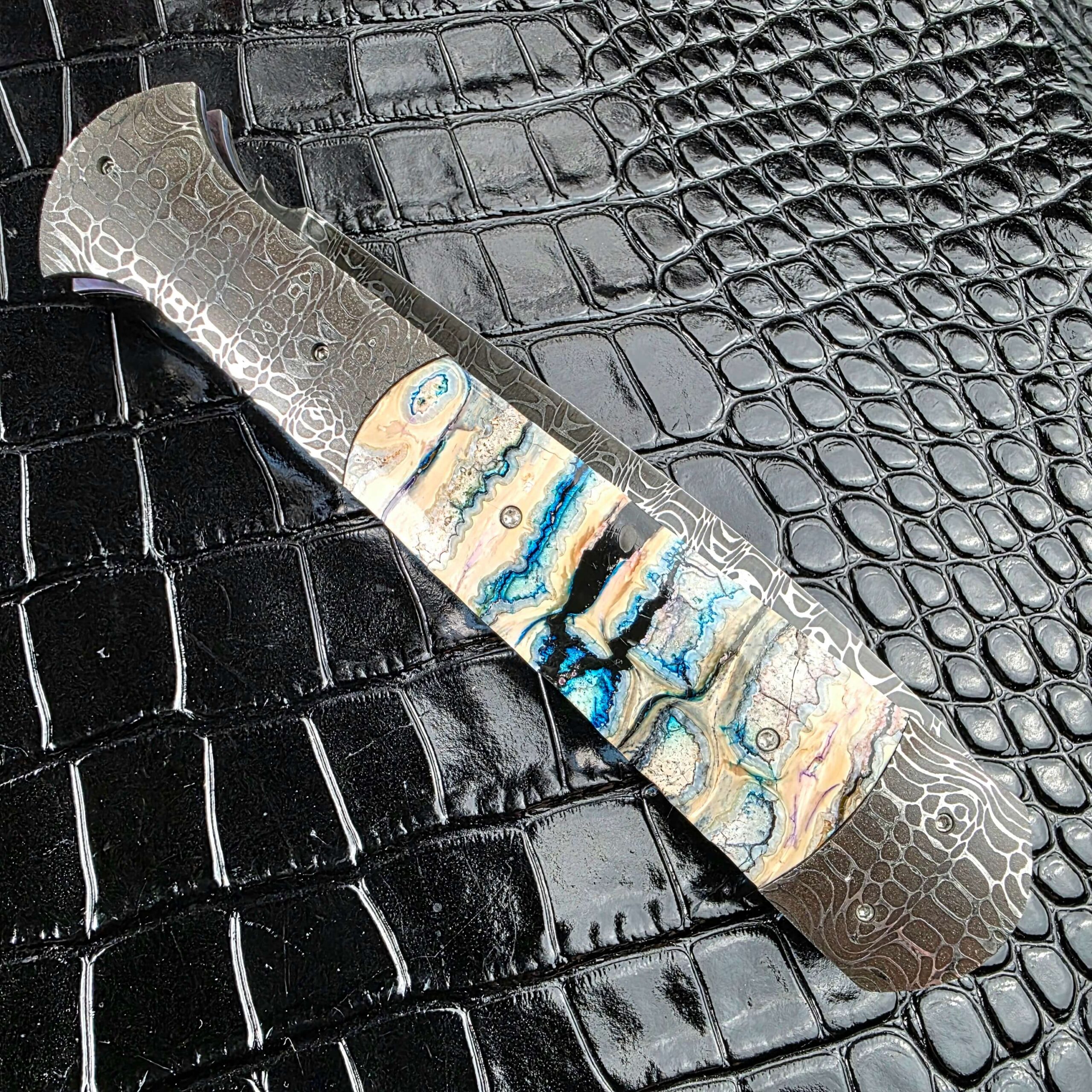 Burn Knives Automatic Dagger closed on the lock side showing the mammoth molar figure