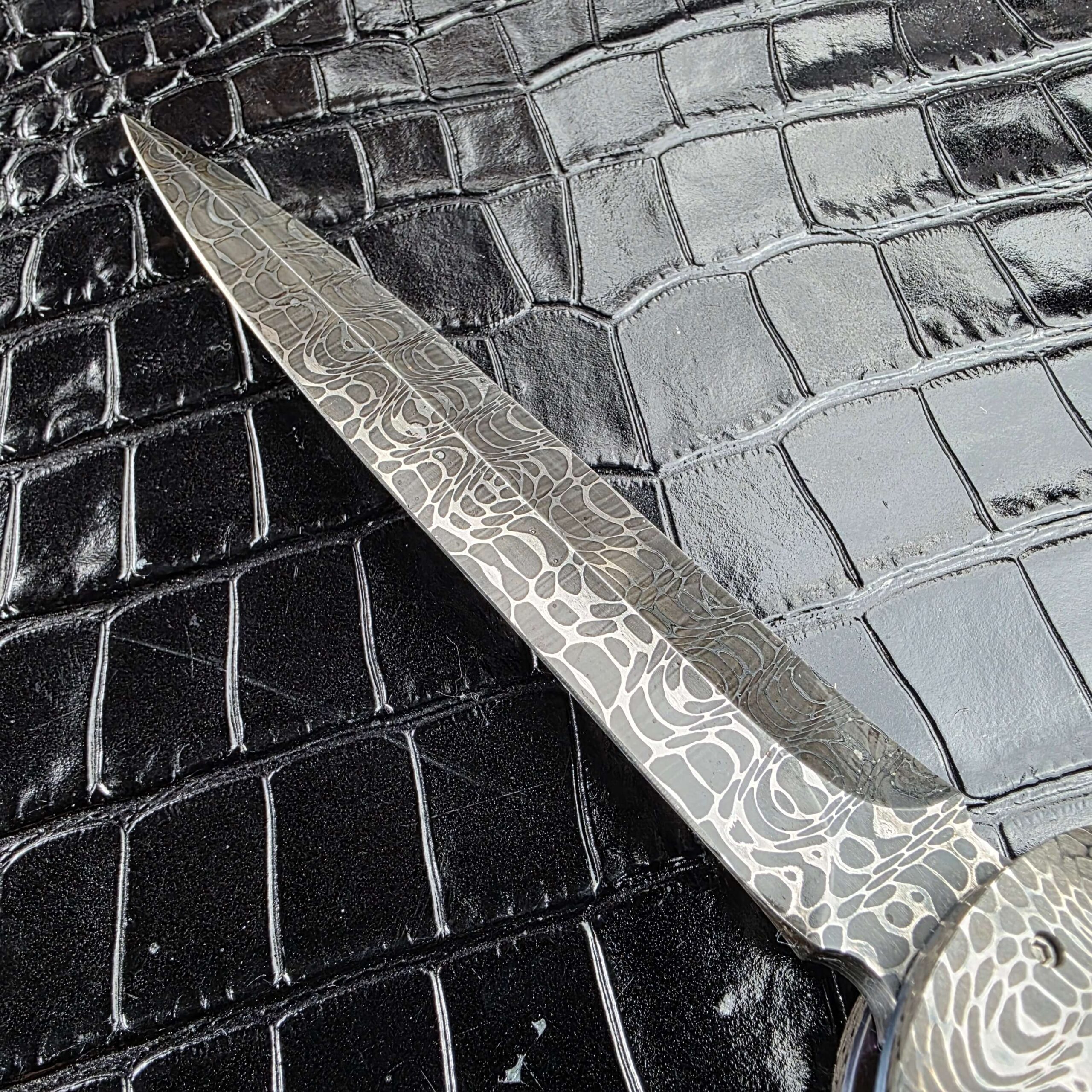 Full dagger blade profile in Chad Nichols Damascus on the Burn Knives Automatic Dagger