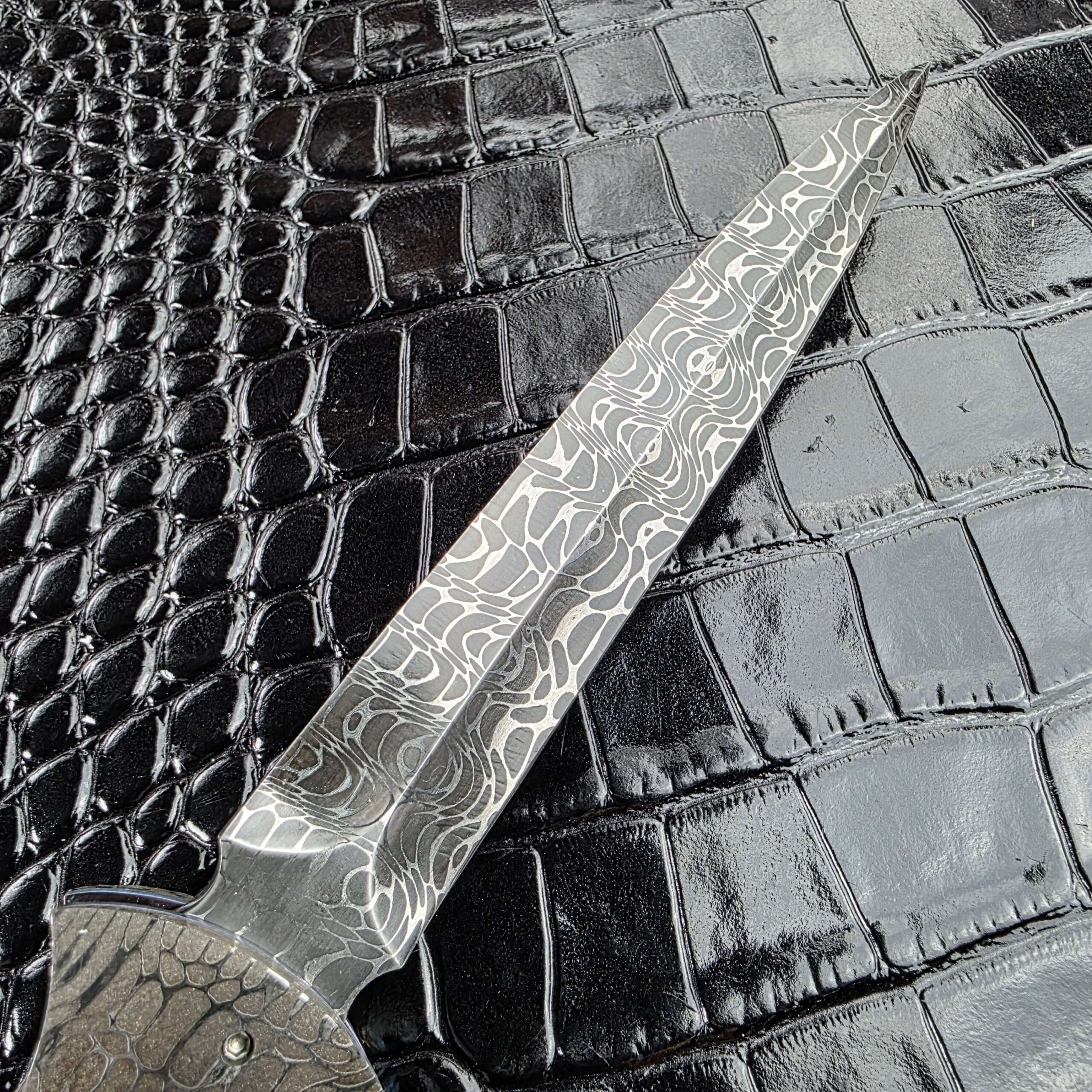 Symmetrical dagger grind and central ridge on the Burn Knives Automatic Dagger