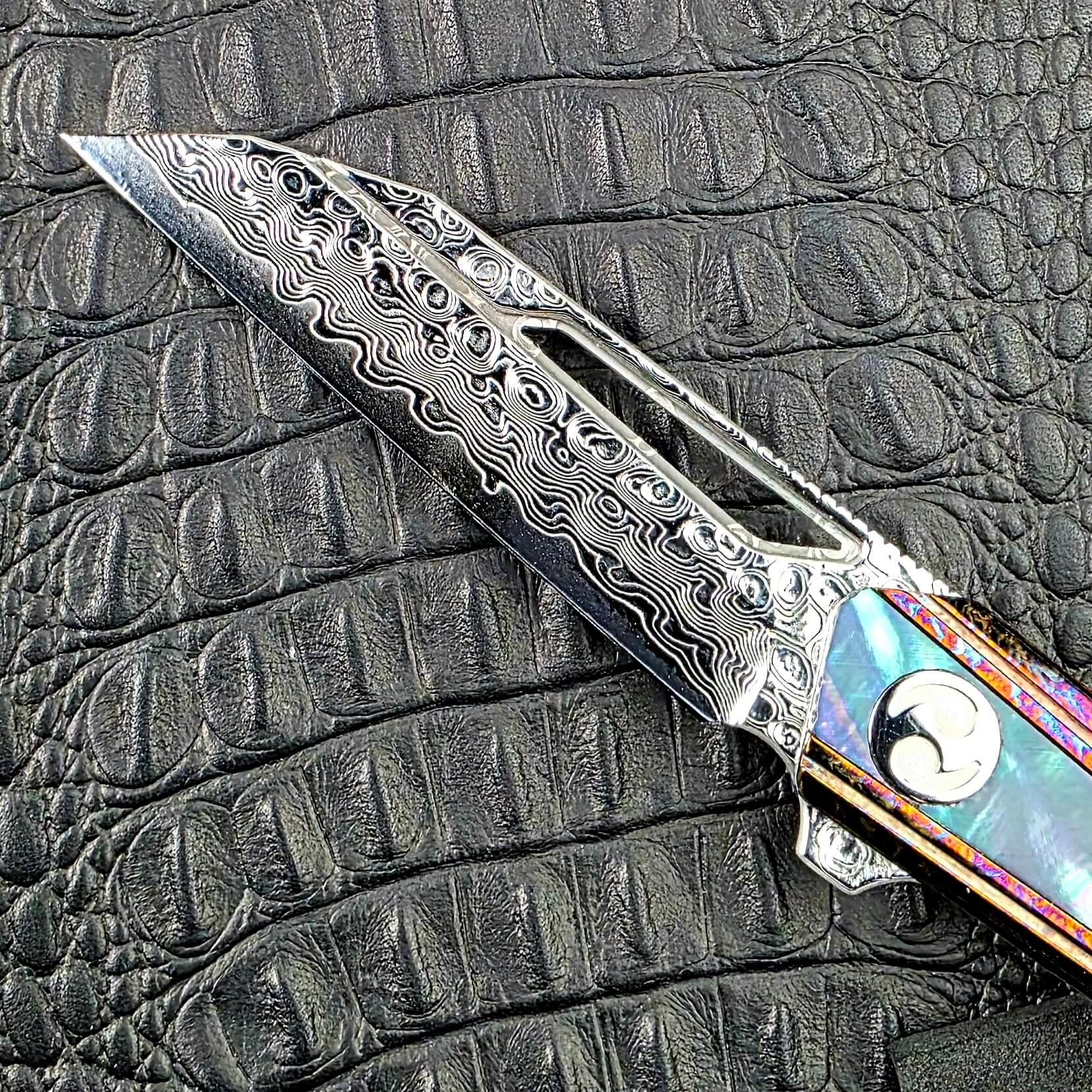 Deep etched 67 layer VG-10 Damascus blade of the Dew Hara Kabuki with its milled window