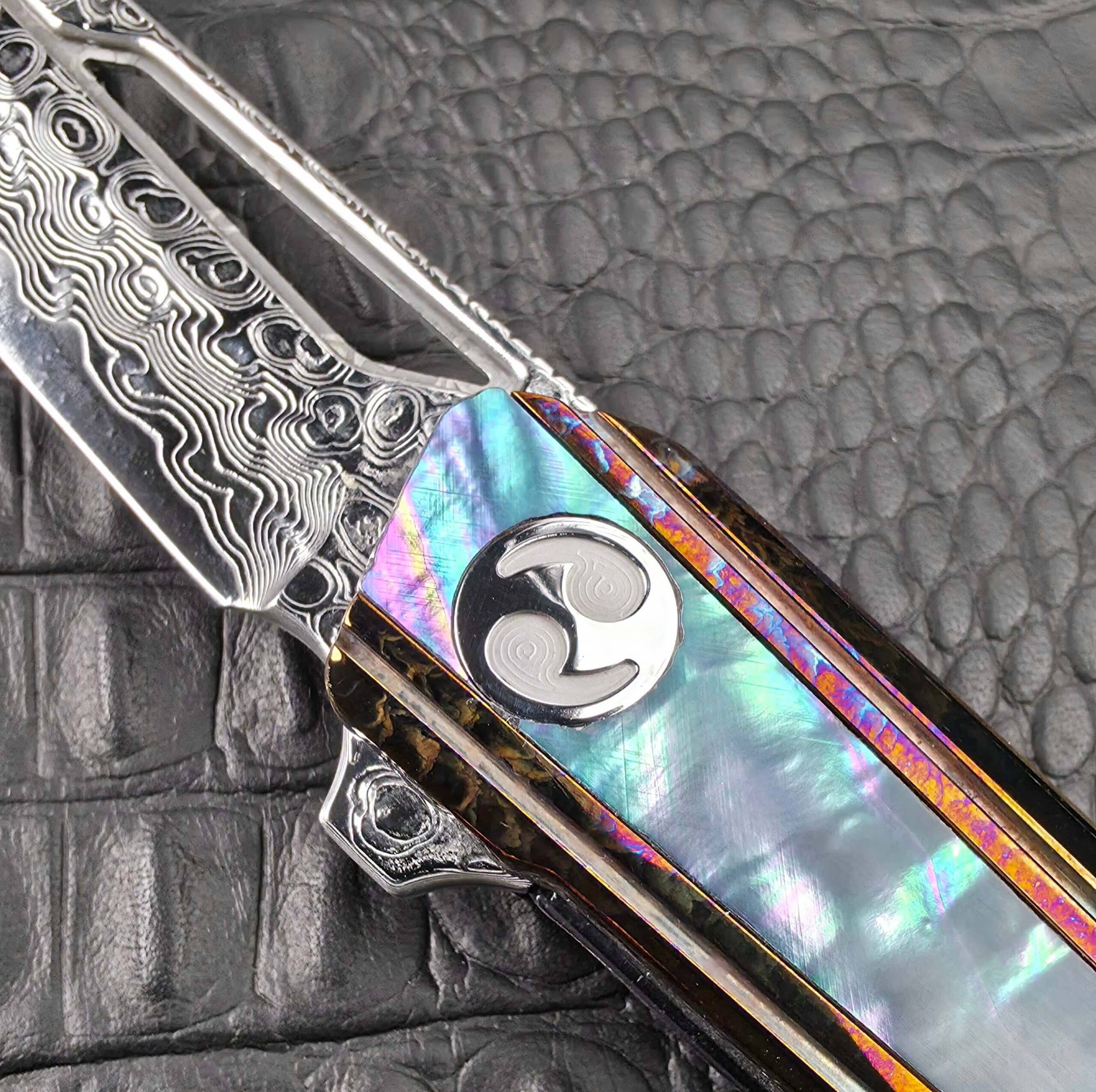 Polished pivot and Damascus flipper tab of the Dew Hara Kabuki, show side