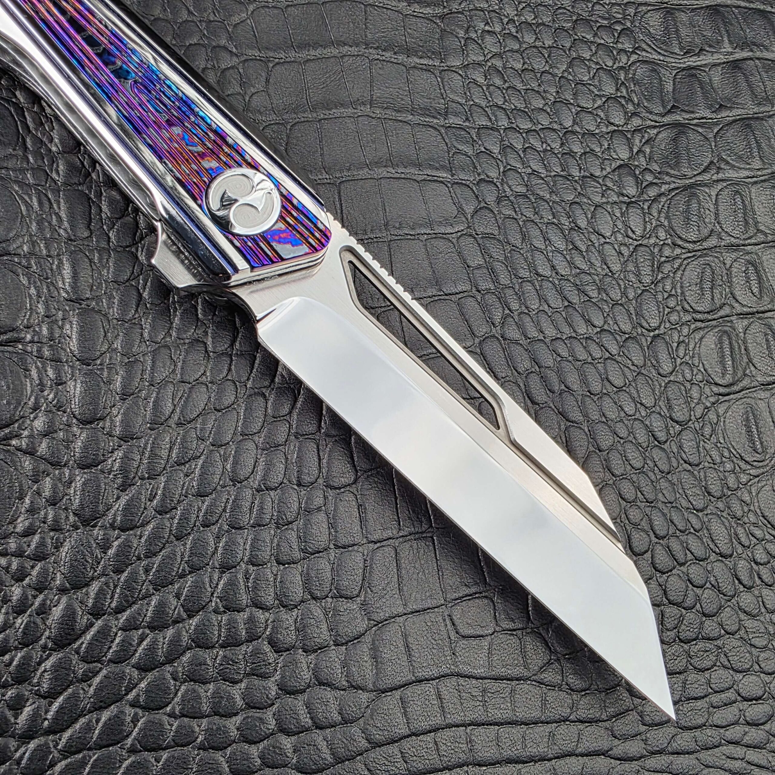High polish M390 blade of the Dew Hara Kabuki with its milled window and straight edge