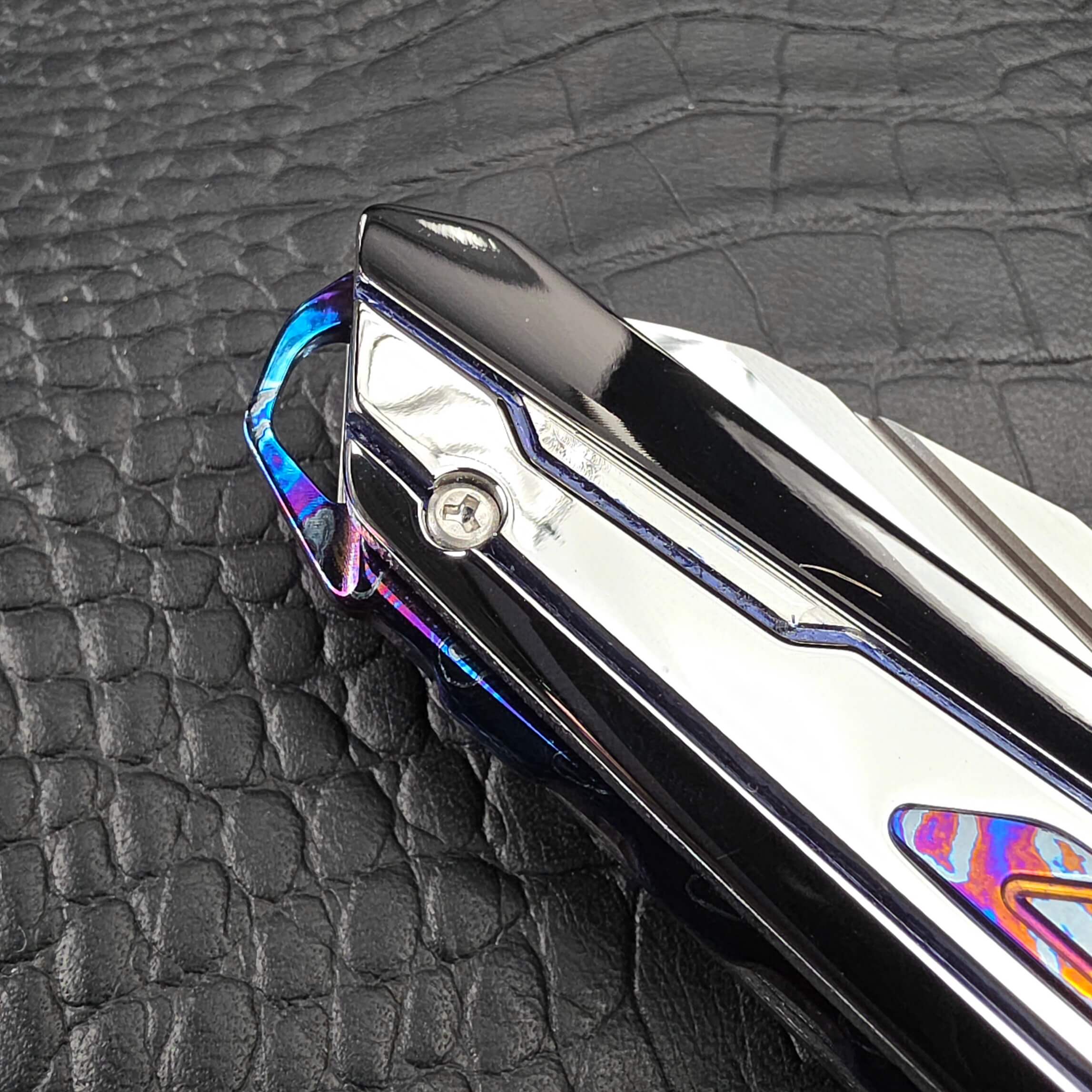 Macro of the Zircuti pocket clip and engraved Dew Hara emblem on the Dew Hara Kabuki