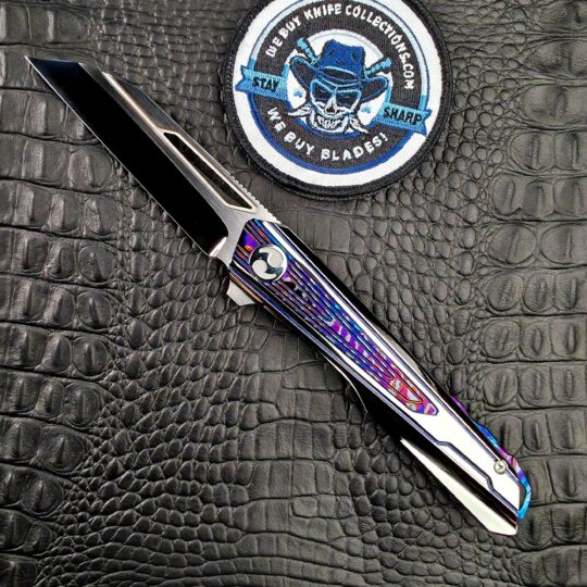 Dew Hara Kabuki open on its show side beside the We Buy Knife Collections patch