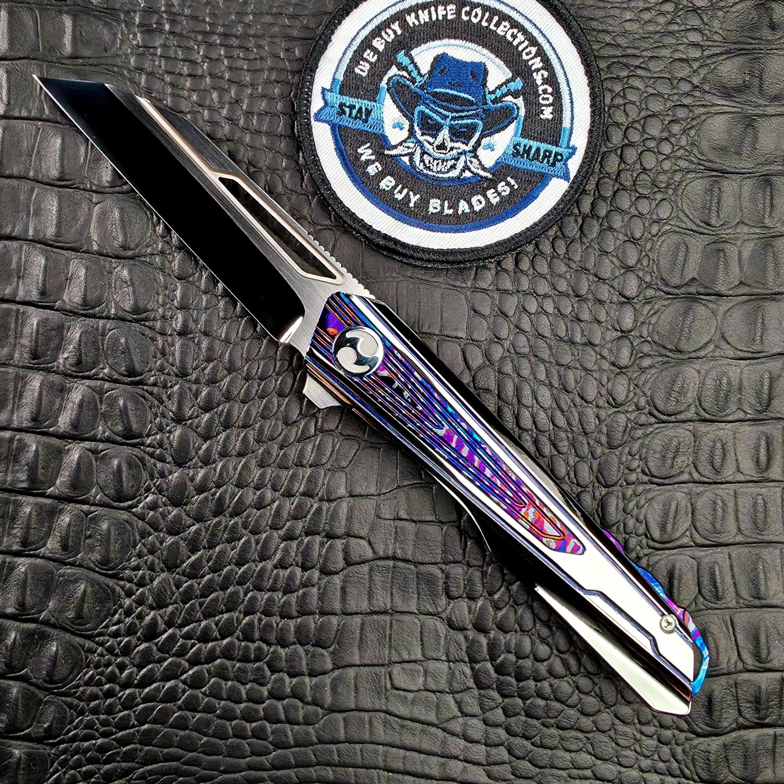 Dew Hara Kabuki open on its show side beside the We Buy Knife Collections patch