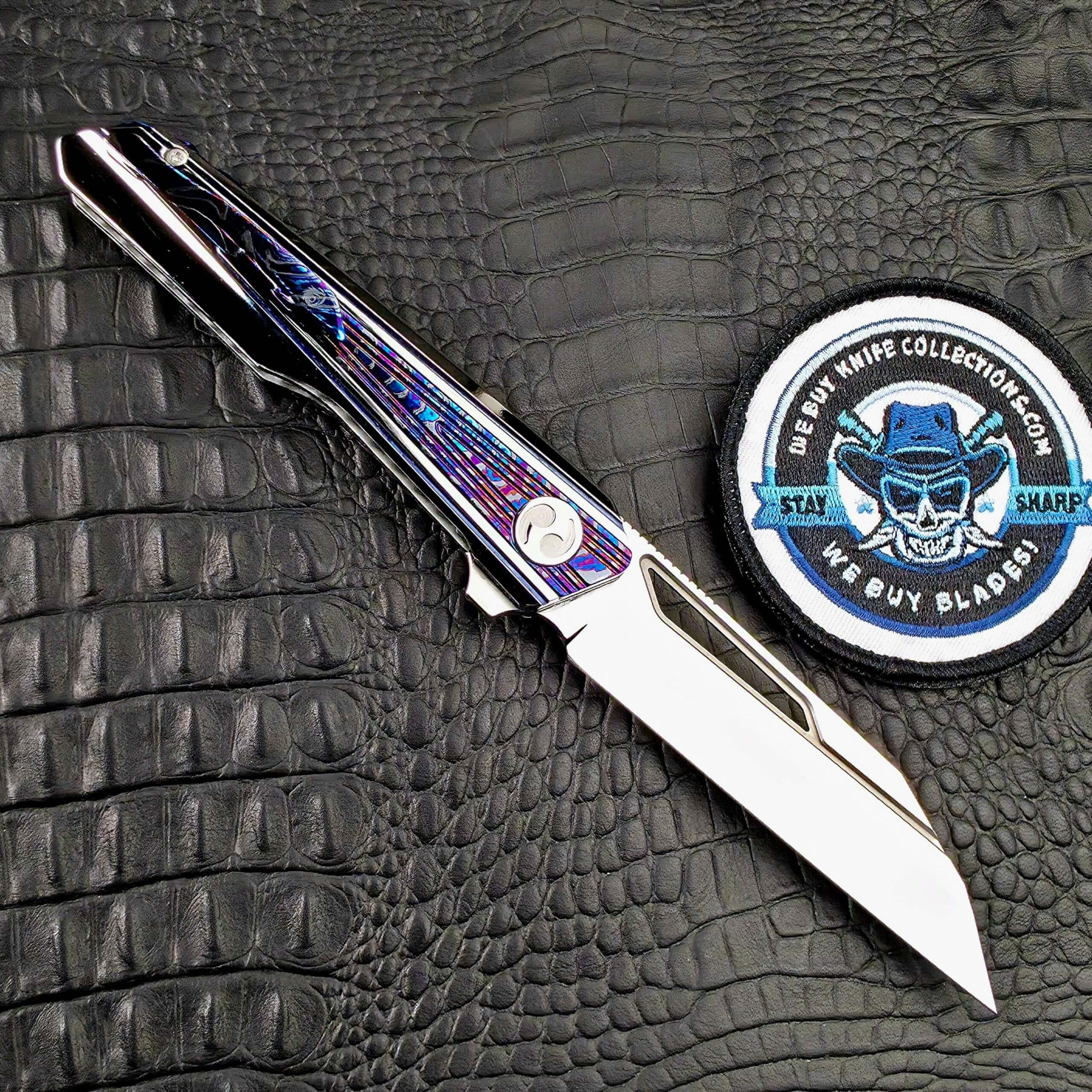 Dew Hara Kabuki open on its clip side with the Zircuti pocket clip and We Buy Knife Collections patch