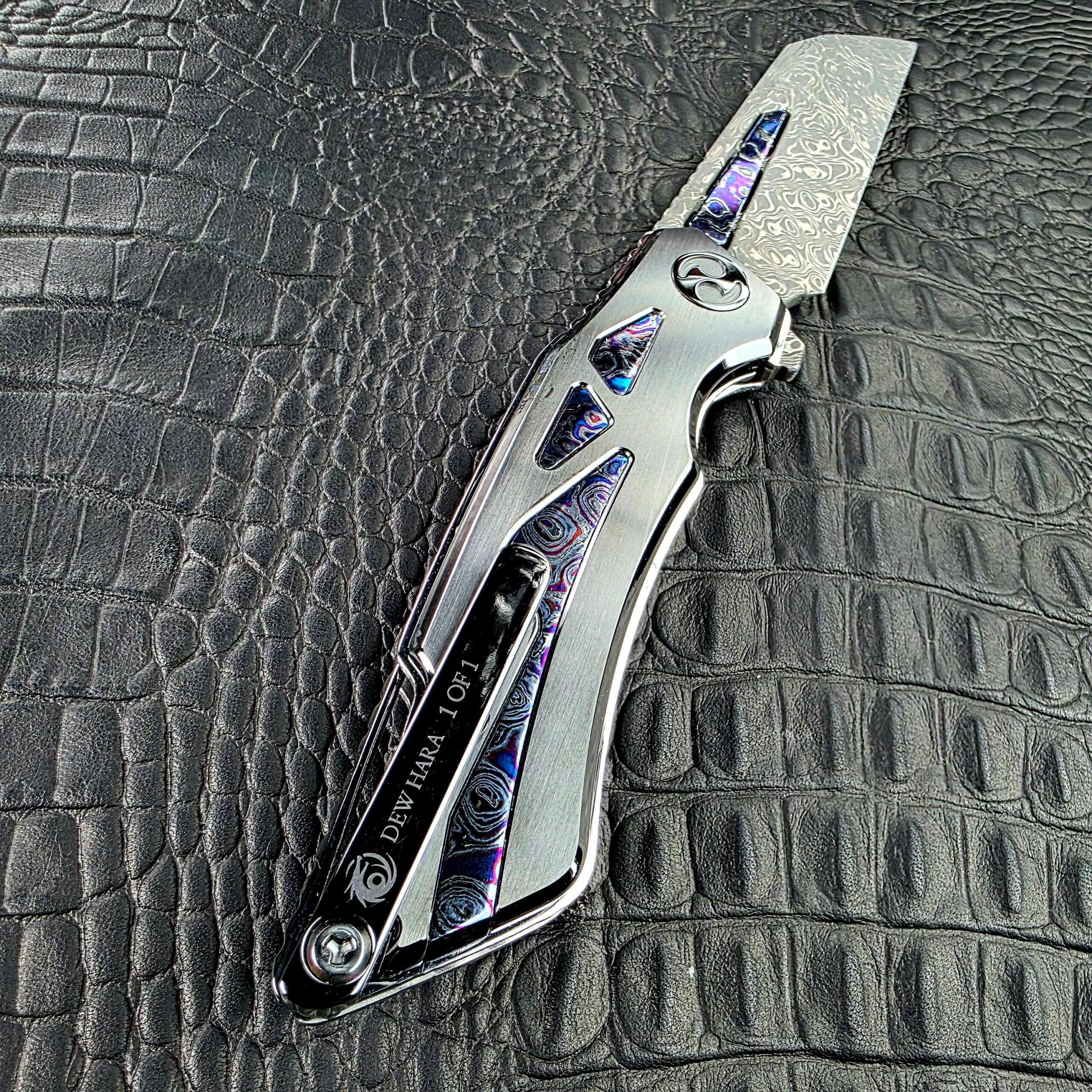 Dew Hara Seismic Damascus Ray Custom 1 of 1 open on its clip side, showing the DLC Titanium pocket clip and Zircuti inlays