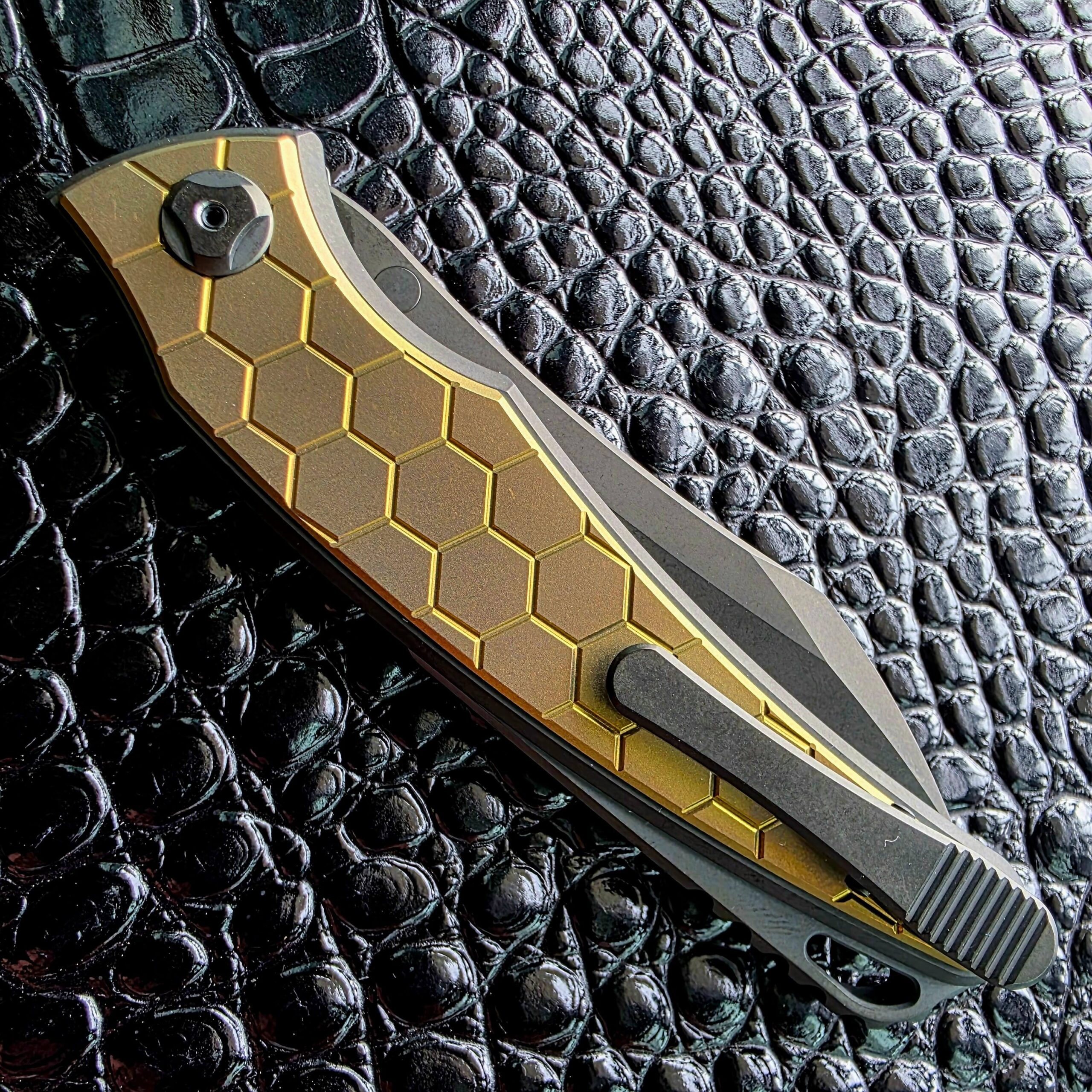 Hawk Talon Auto closed on the clip side with the titanium Gripclip over the gold honeycomb inlay