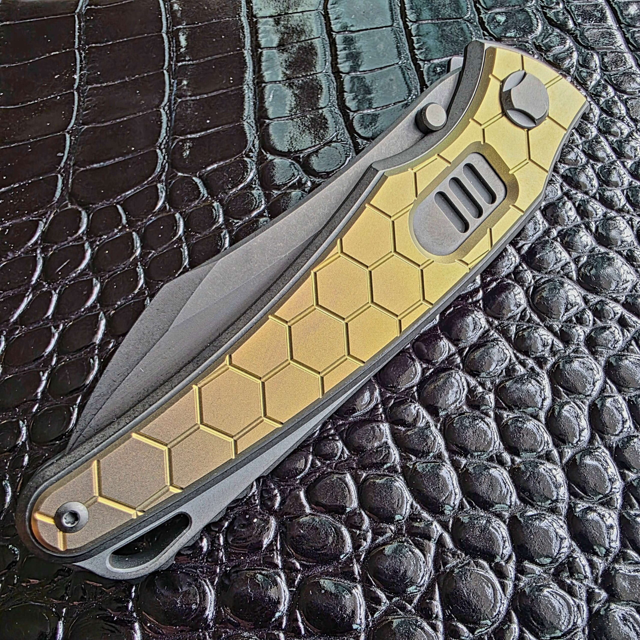 Angled view of the gold anodized honeycomb milled titanium inlay on the closed Hawk Talon Auto