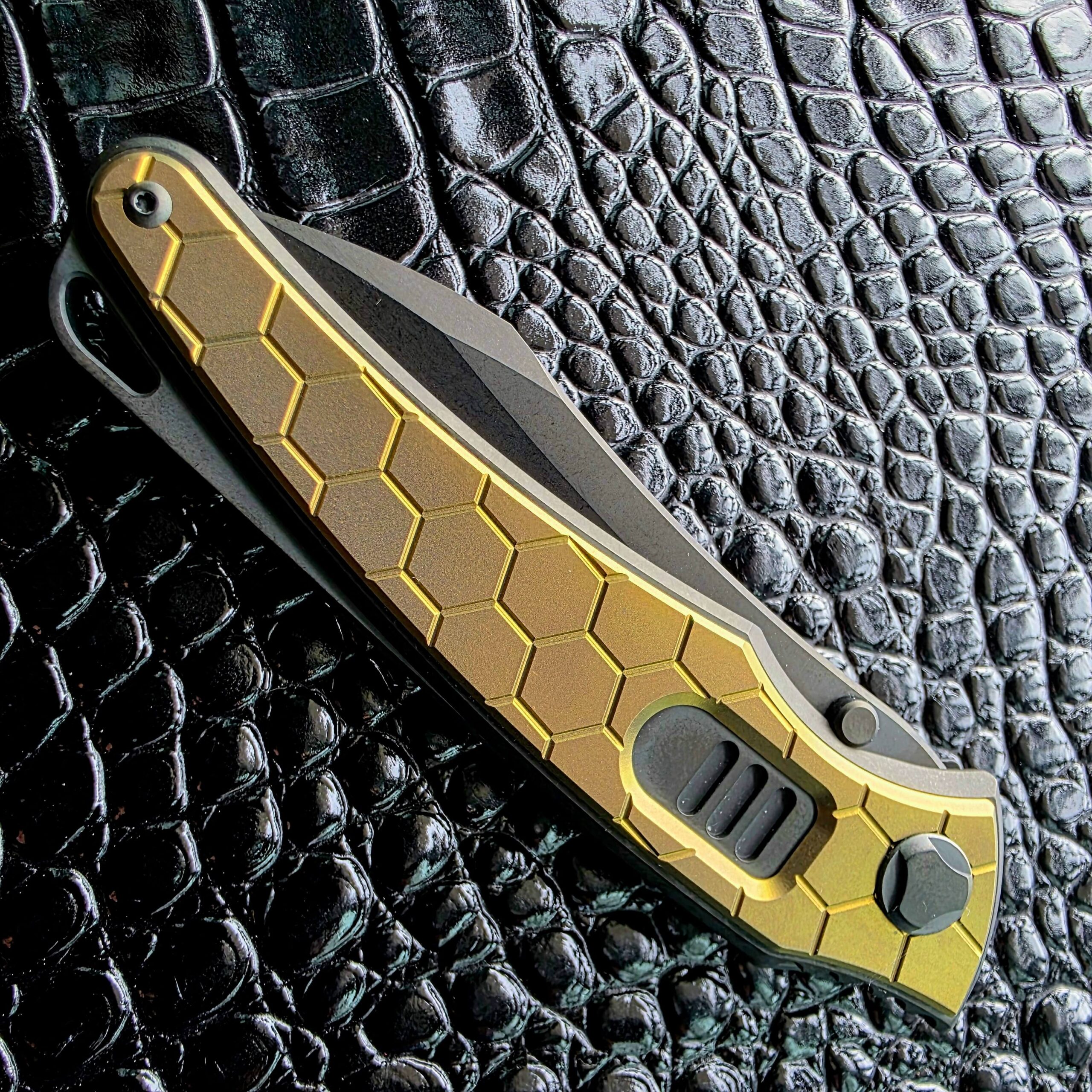 Hawk Talon Auto closed on the show side, gold honeycomb inlay in a DLC titanium frame