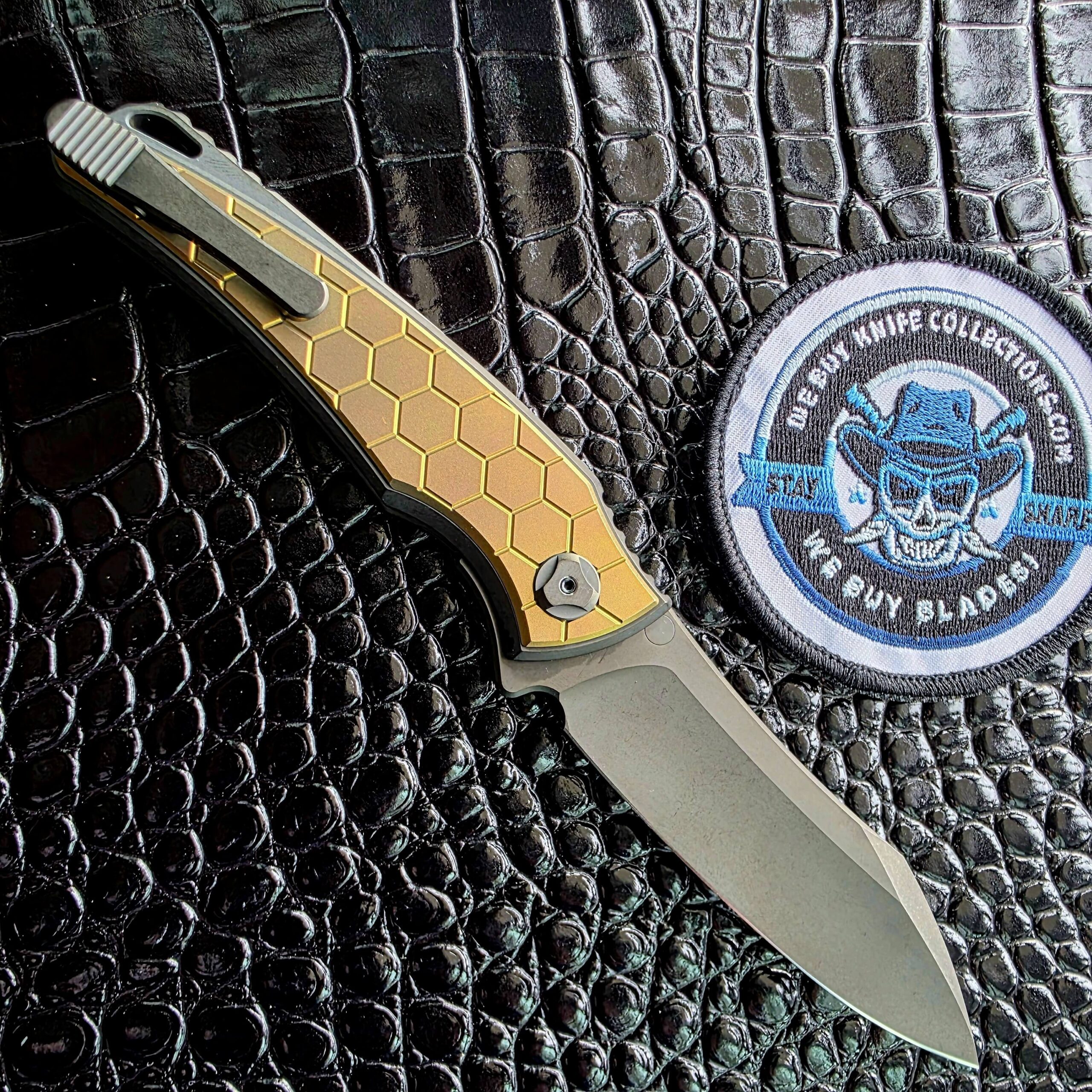 Hawk Talon Auto open on the clip side showing the tumbled titanium Gripclip, We Buy Knife Collections patch in frame