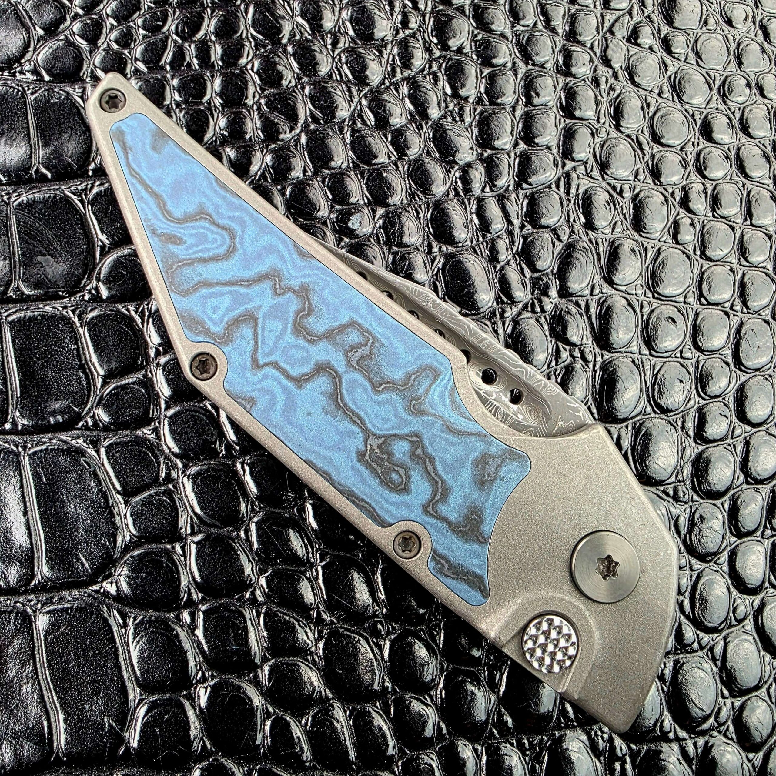 Closed Hypercut Dharma on its show side with the Black Timascus inlay, Zirconium pivot and textured push button