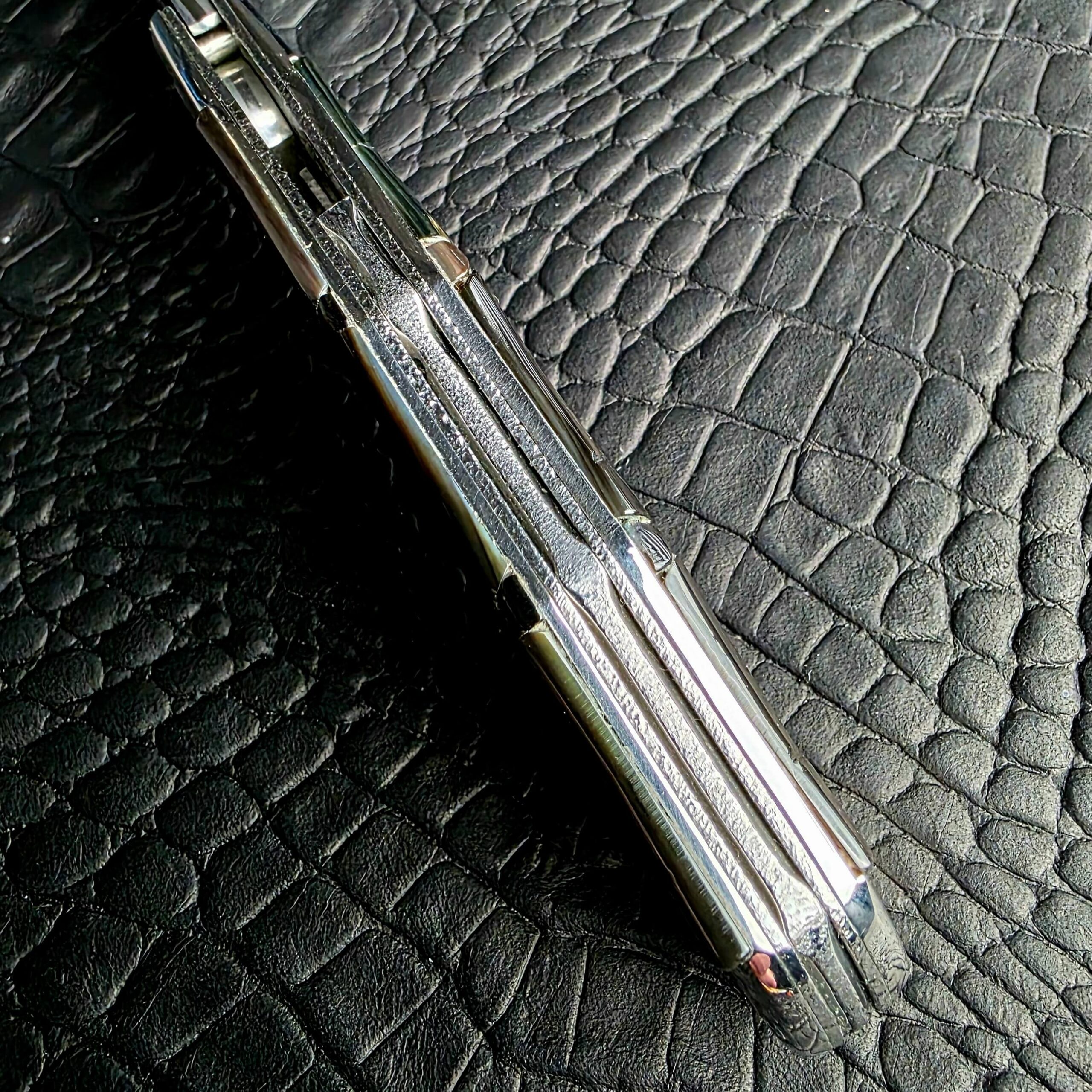 Spine view of the Koji Hara Take Flipper showing the textured Stainless Steel liners