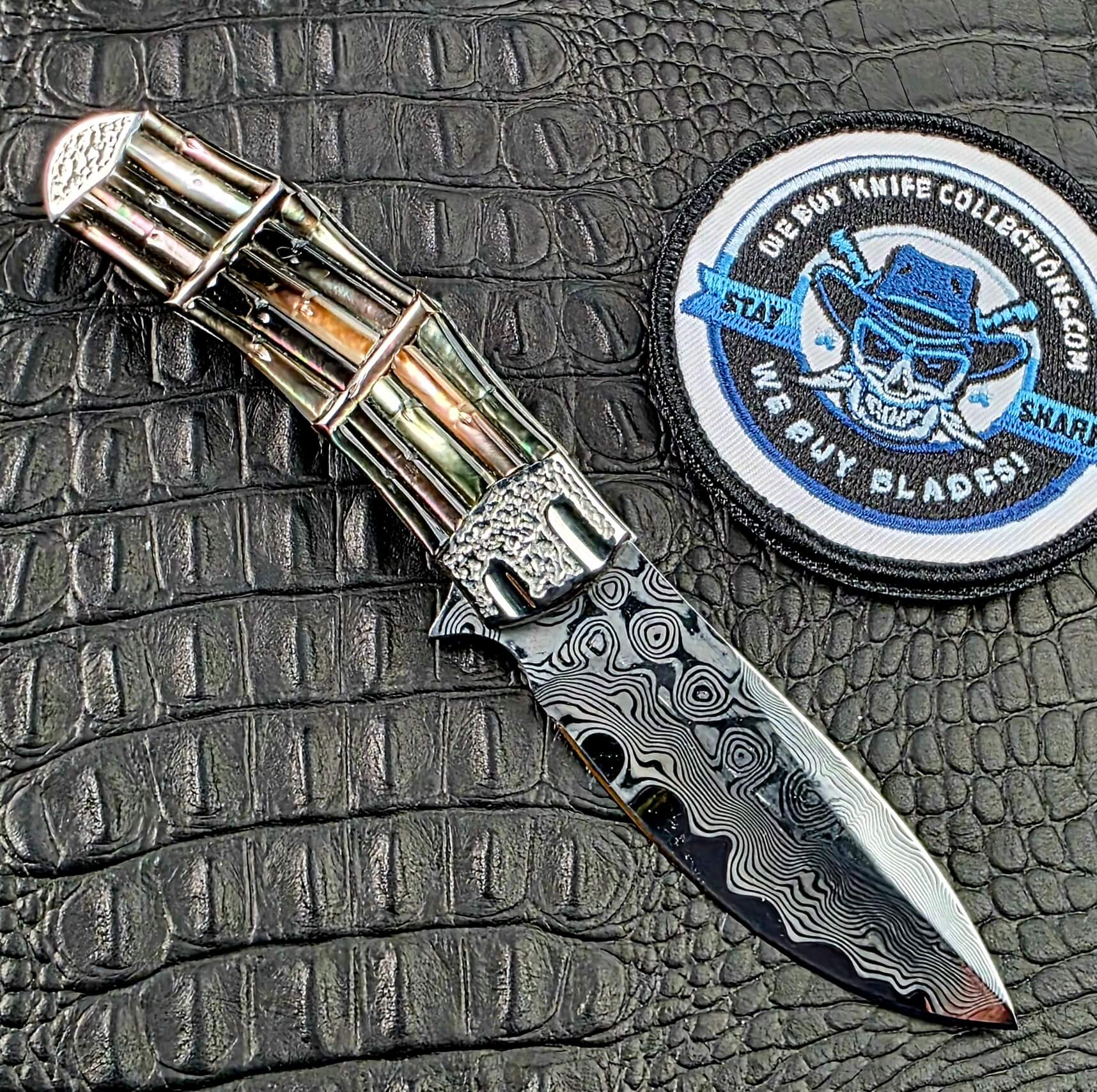 Koji Hara Take Flipper open on its reverse side beside the We Buy Knife Collections patch