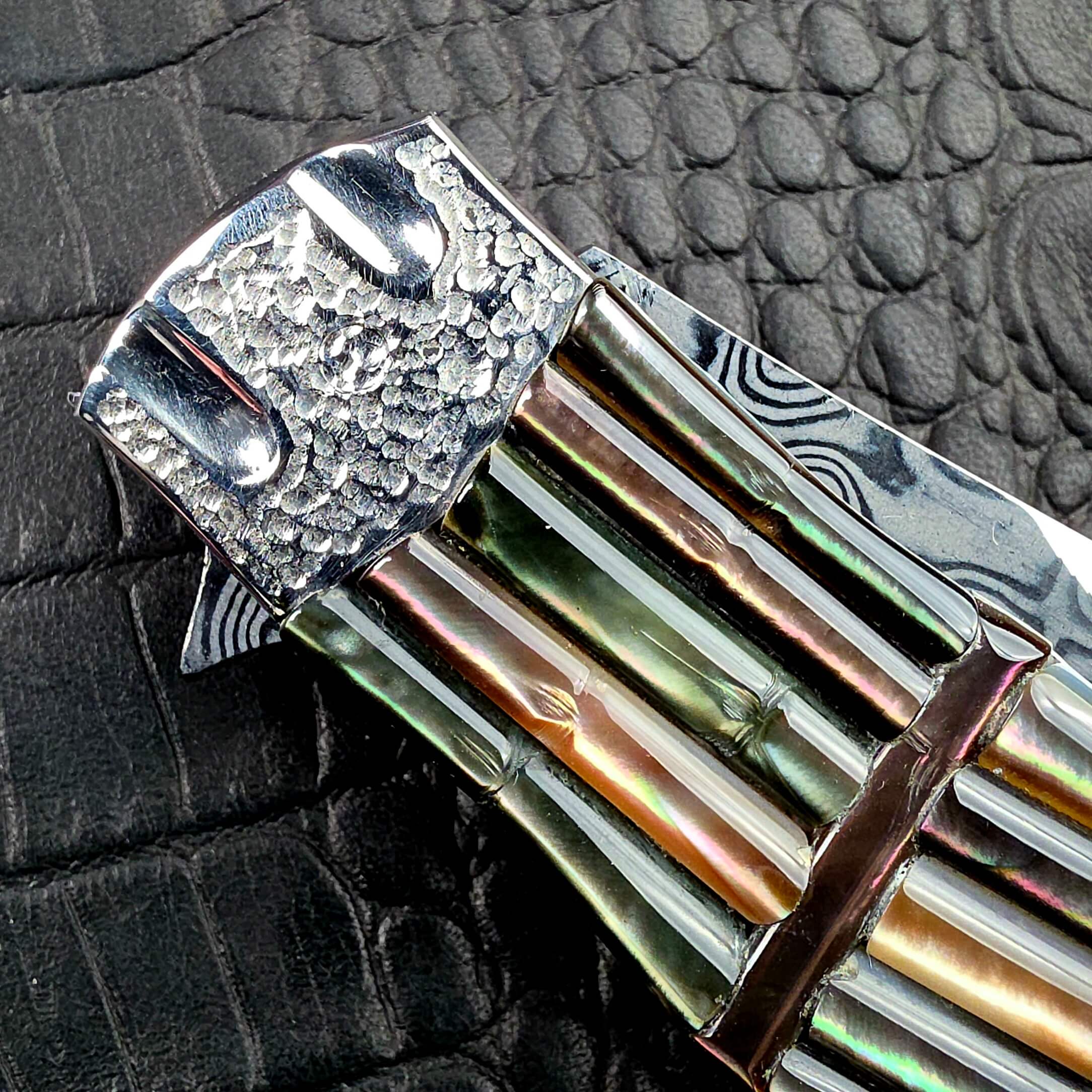 Macro of the tsuchime front bolster and carved scales of the Koji Hara Take Flipper