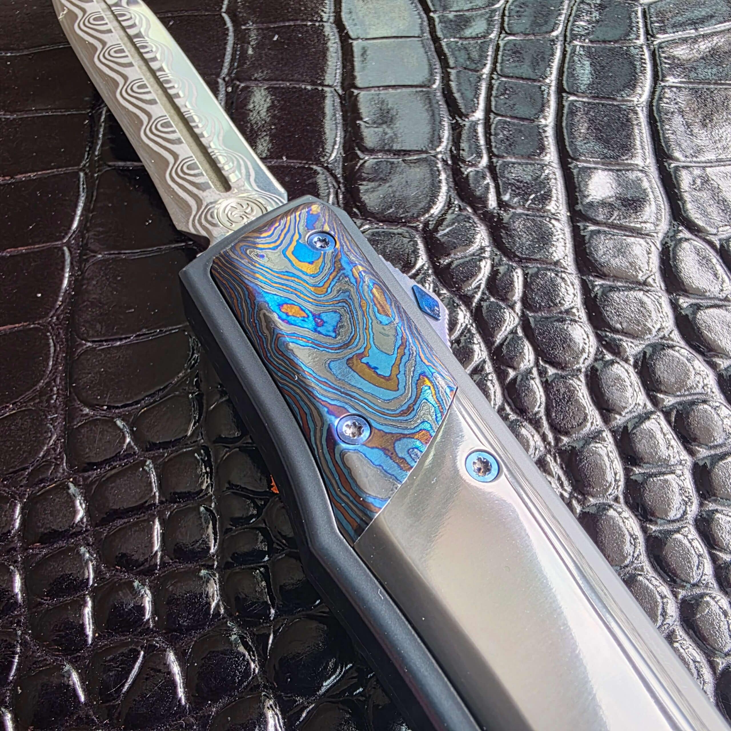 Black Timascus bolster meeting the mirror-polished zirconium scale on the Patrick Famin GOTF Mini