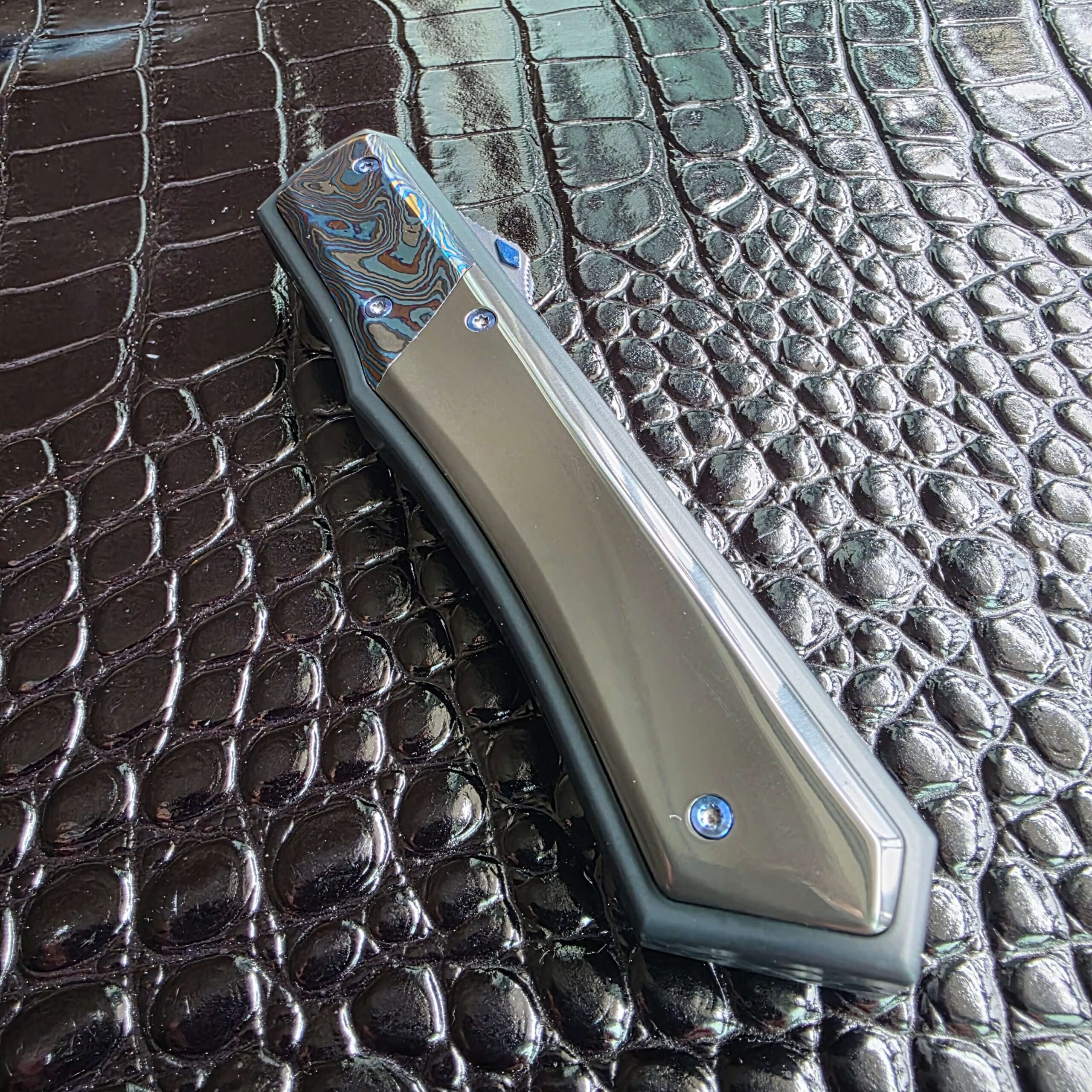 Mirror-polished zirconium scale on the closed Patrick Famin GOTF Mini catching light