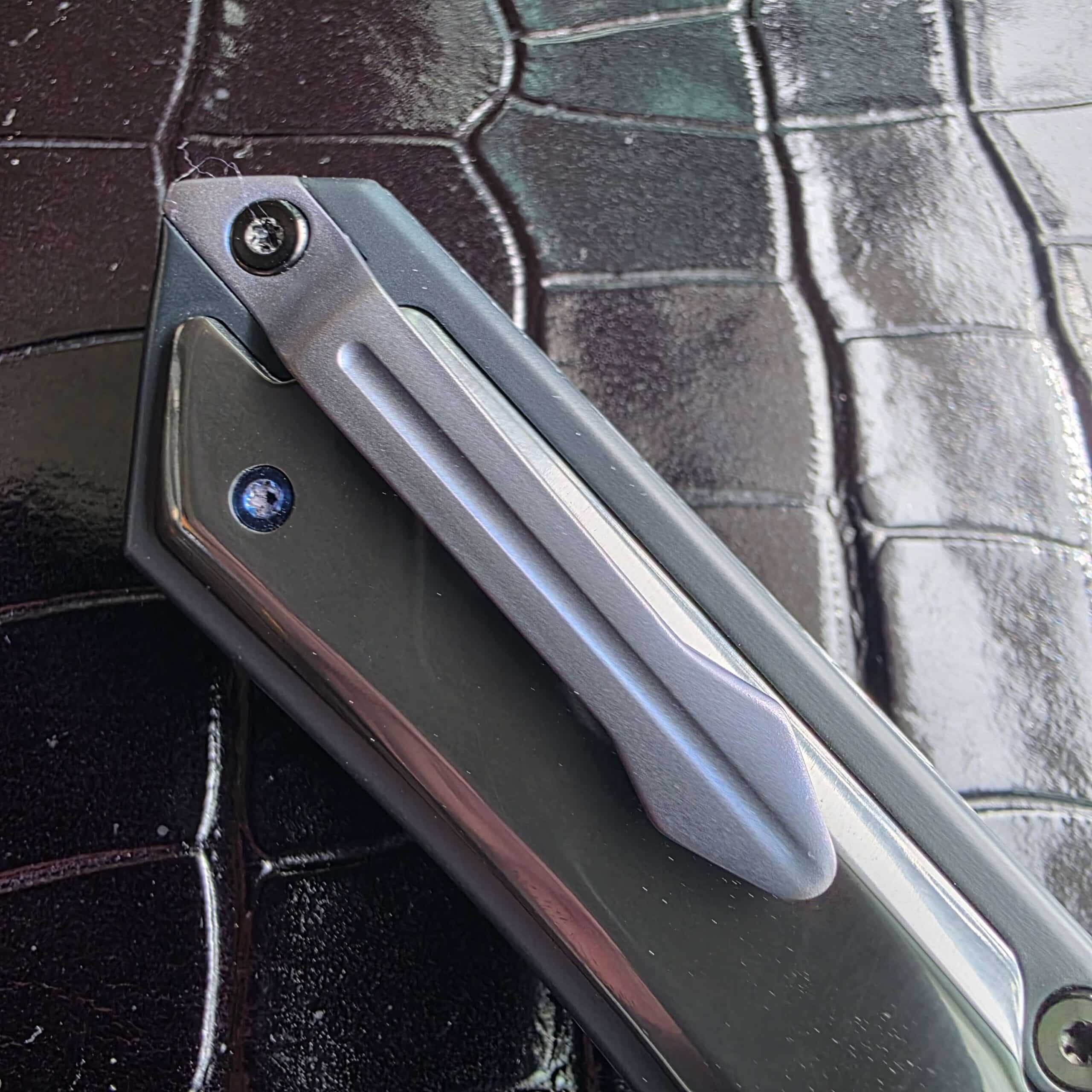 Sculpted titanium pocket clip on the Patrick Famin GOTF Mini, mounted for tip-down carry