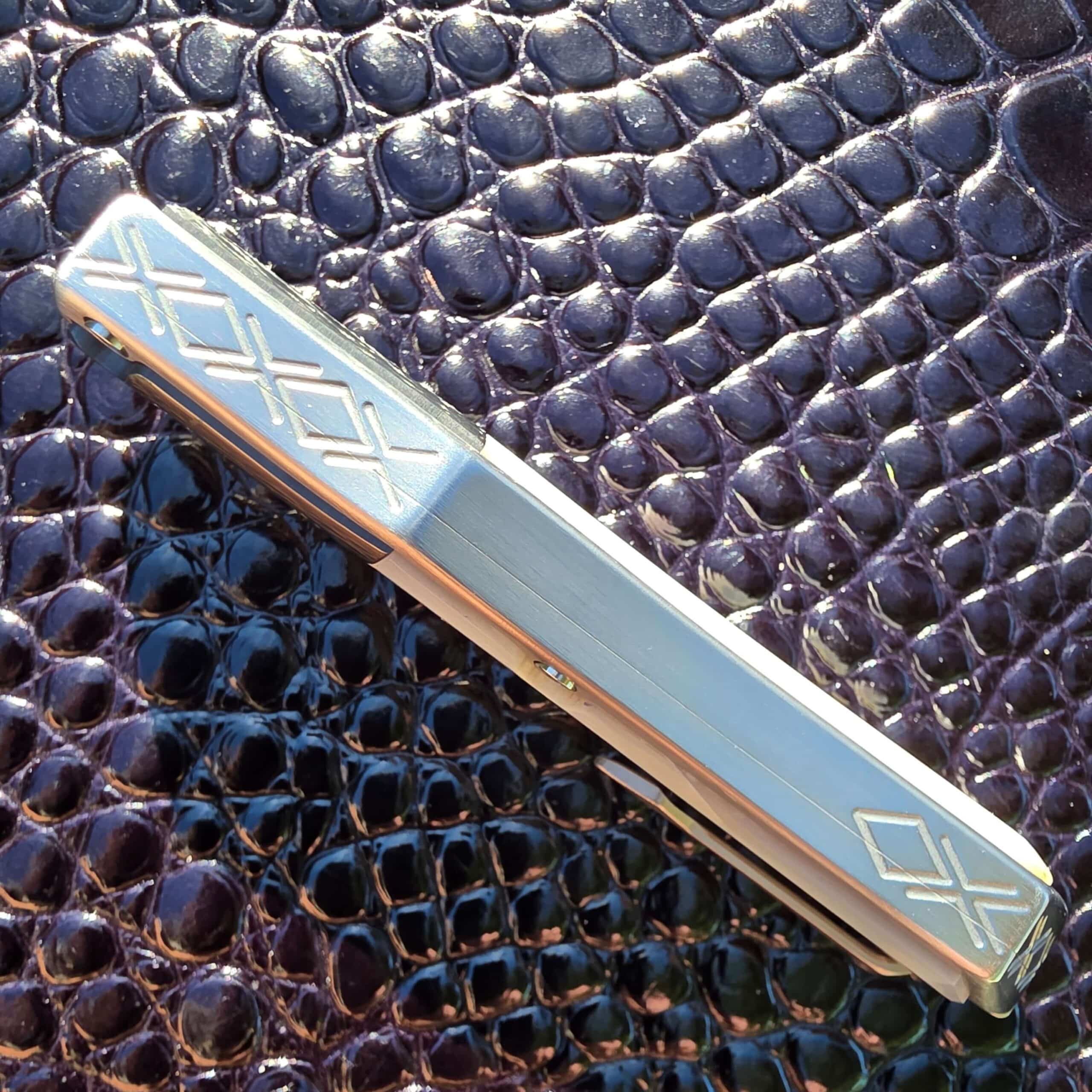 Milled diamond pattern along the spine of the Patrick Famin Mother of Pearl G.O.T.F. Mini with the thumb slide in frame