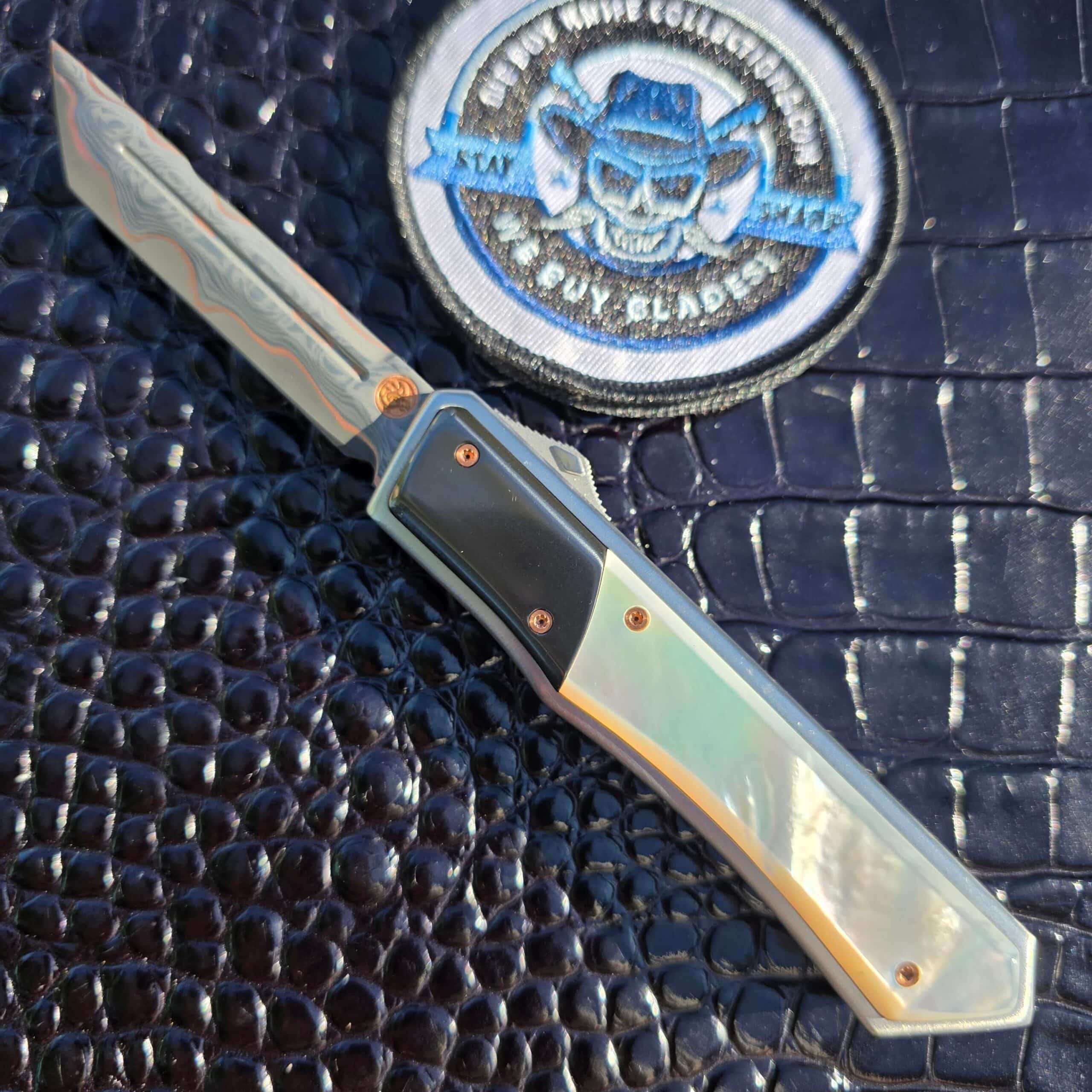 Patrick Famin Mother of Pearl G.O.T.F. Mini open, showing the Baker Forge CopperMai dagger blade, zirconium bolsters and mother of pearl scales