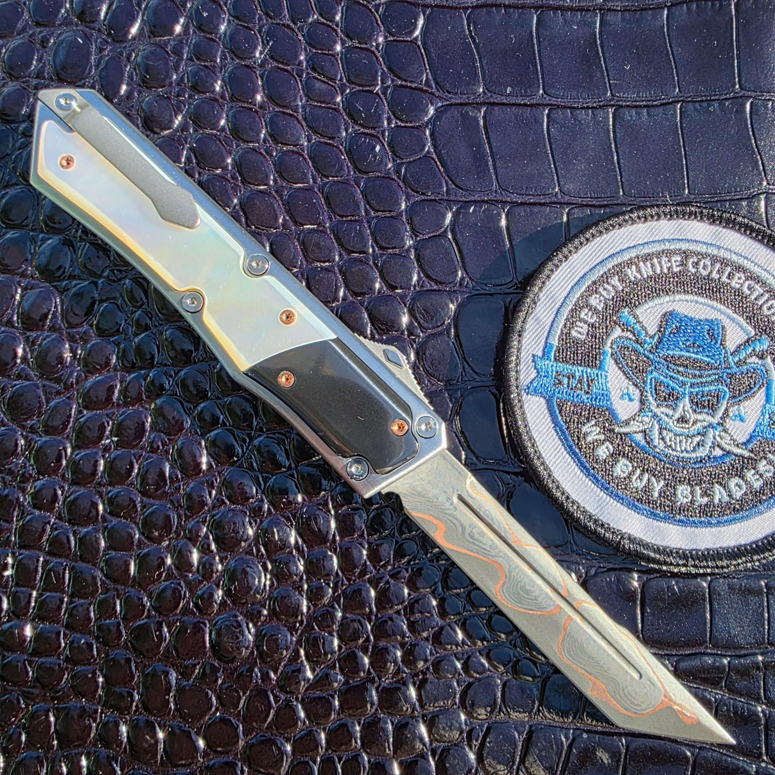 Clip side of the Patrick Famin Mother of Pearl G.O.T.F. Mini open, with the titanium pocket clip mounted over the mother of pearl scale