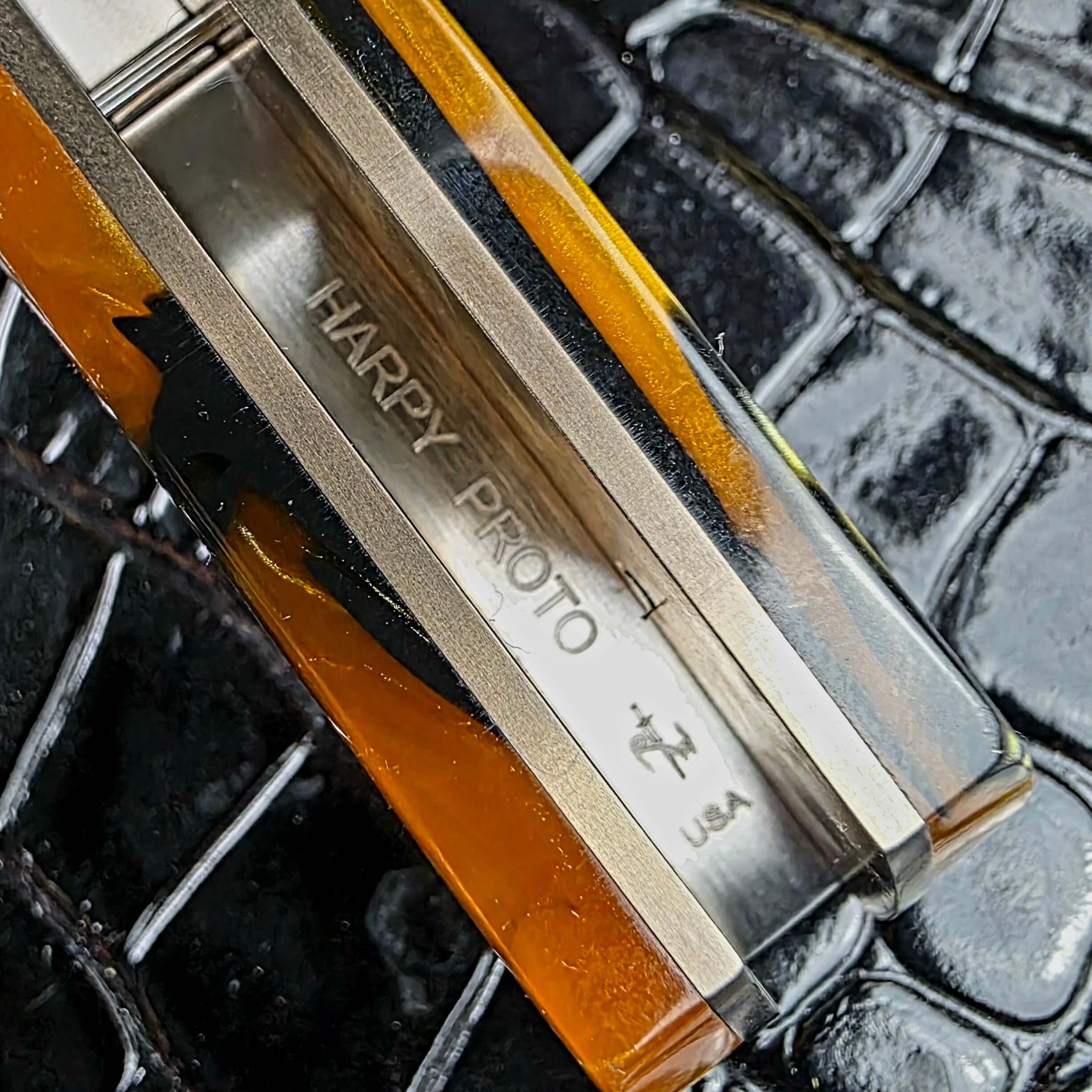 Inside spine of the Reese Weiland Harpy handle, engraved HARPY PROTO, the R.W. bird logo and USA
