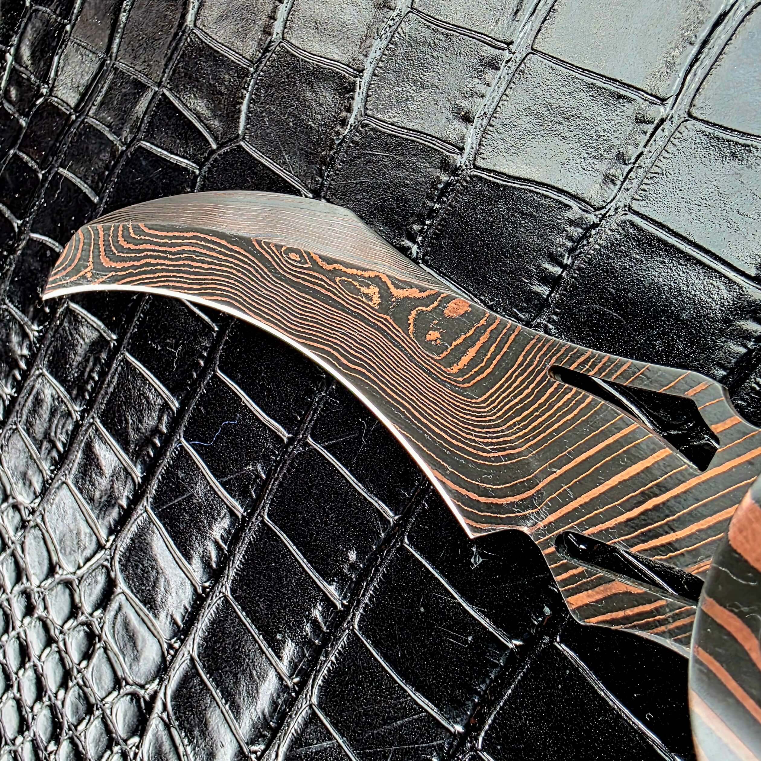 Close view of the Reese Weiland Harpy hawkbill with its two milled slots near the bolster