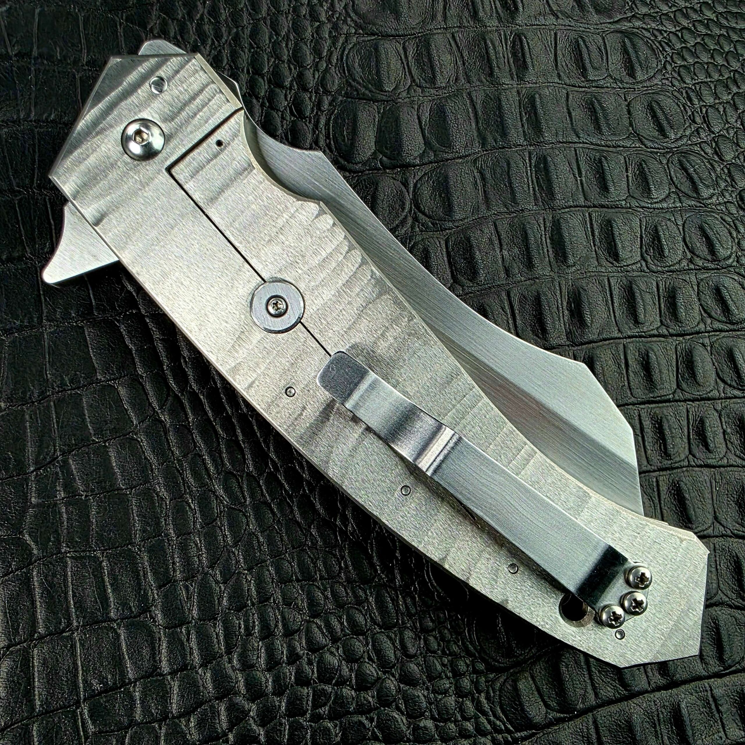 Closed Reese Weiland Strike Prototype 2 on its lock side with the frame lock bar and pocket clip