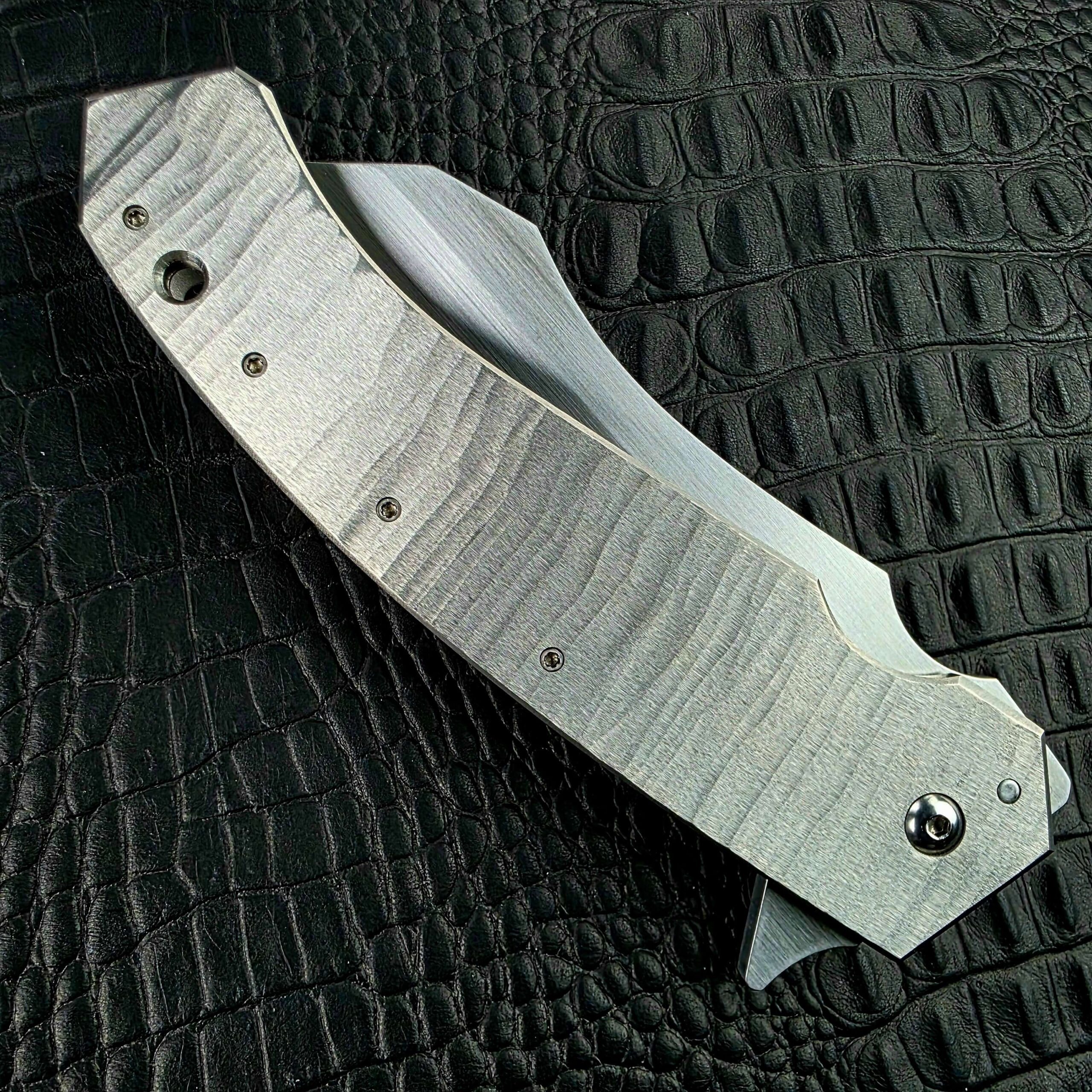 Closed Reese Weiland Strike Prototype 2 on its show side with the hand-ground Titanium frame