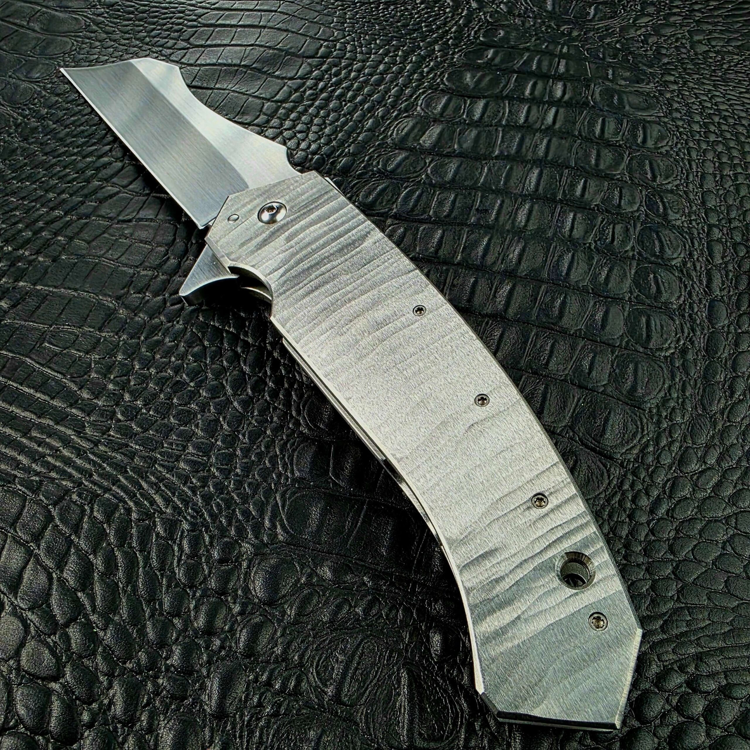 Hand-ground Titanium handle of the open Reese Weiland Strike Prototype 2, show side