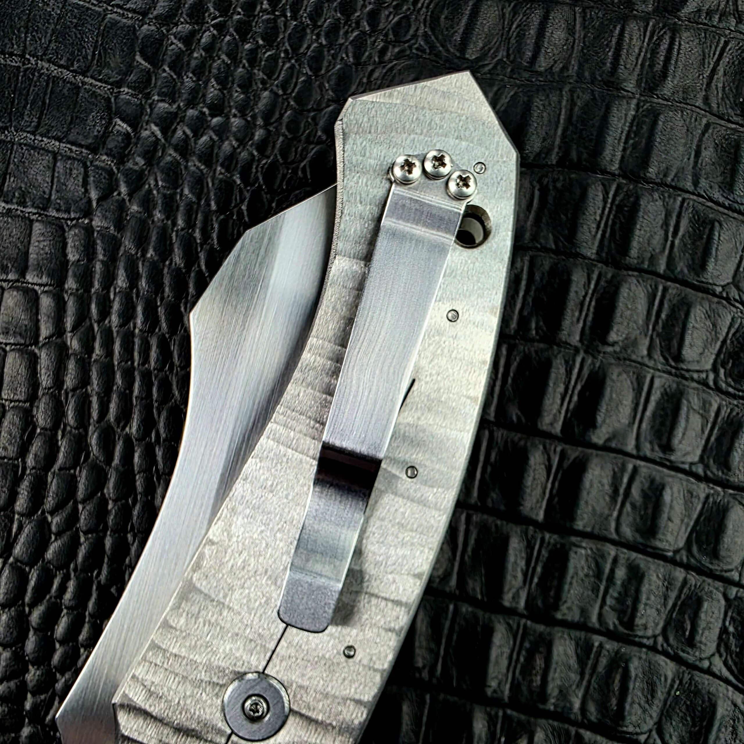 Stainless Steel pocket clip and lanyard hole at the butt of the Reese Weiland Strike Prototype 2
