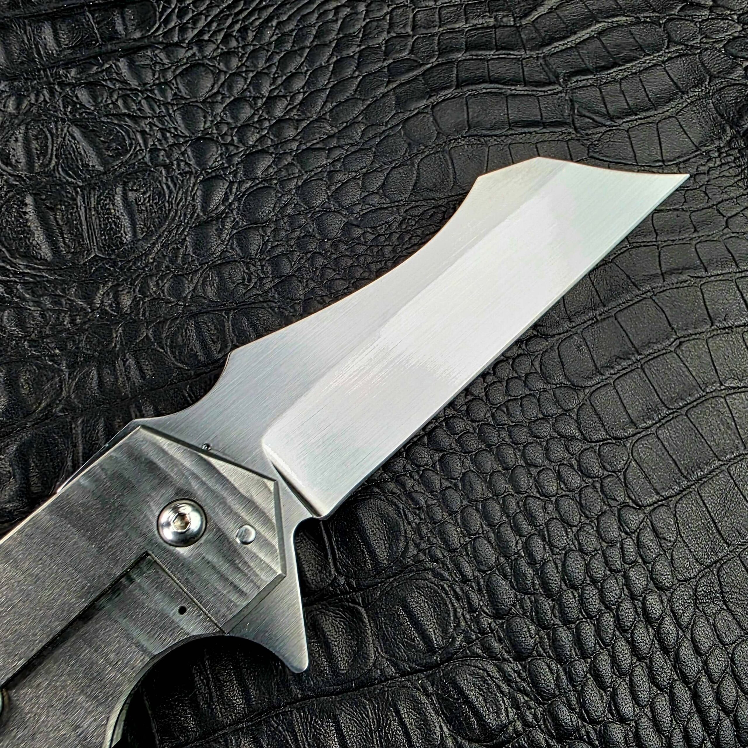 Satin CPM 154 blade and pivot of the Reese Weiland Strike Prototype 2, lock side